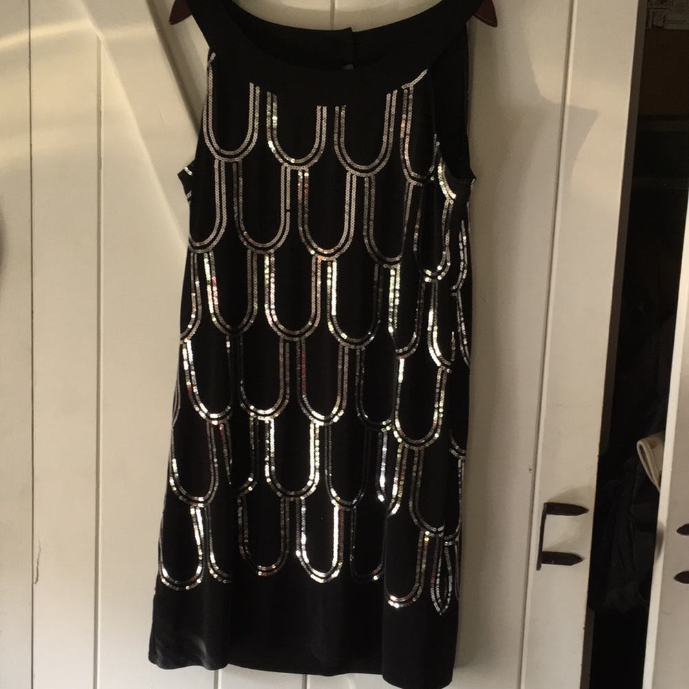 Perfect black dress with sequin detail.  Flattering neckline.